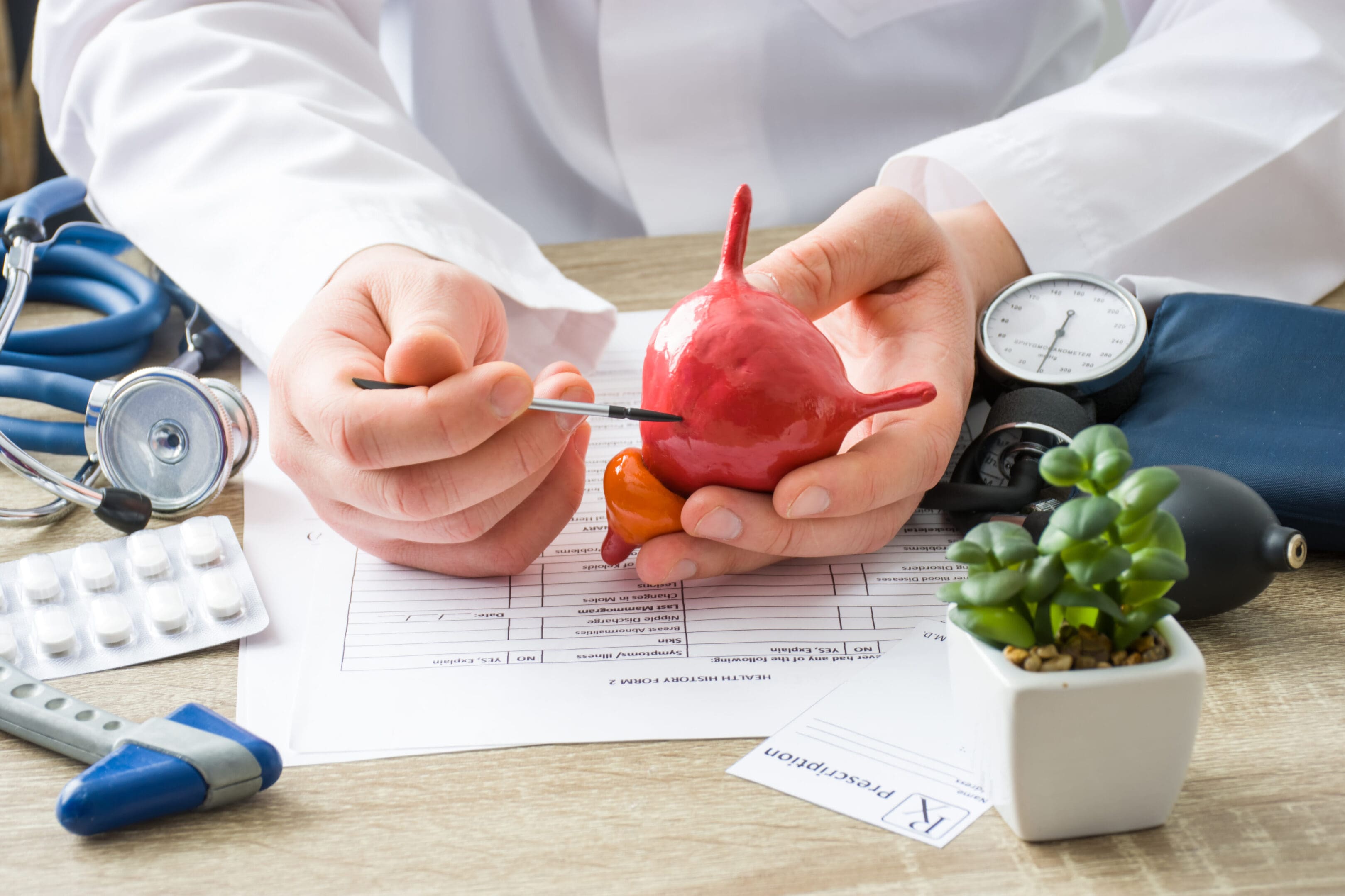 A person holding an apple and carrot on top of paper.