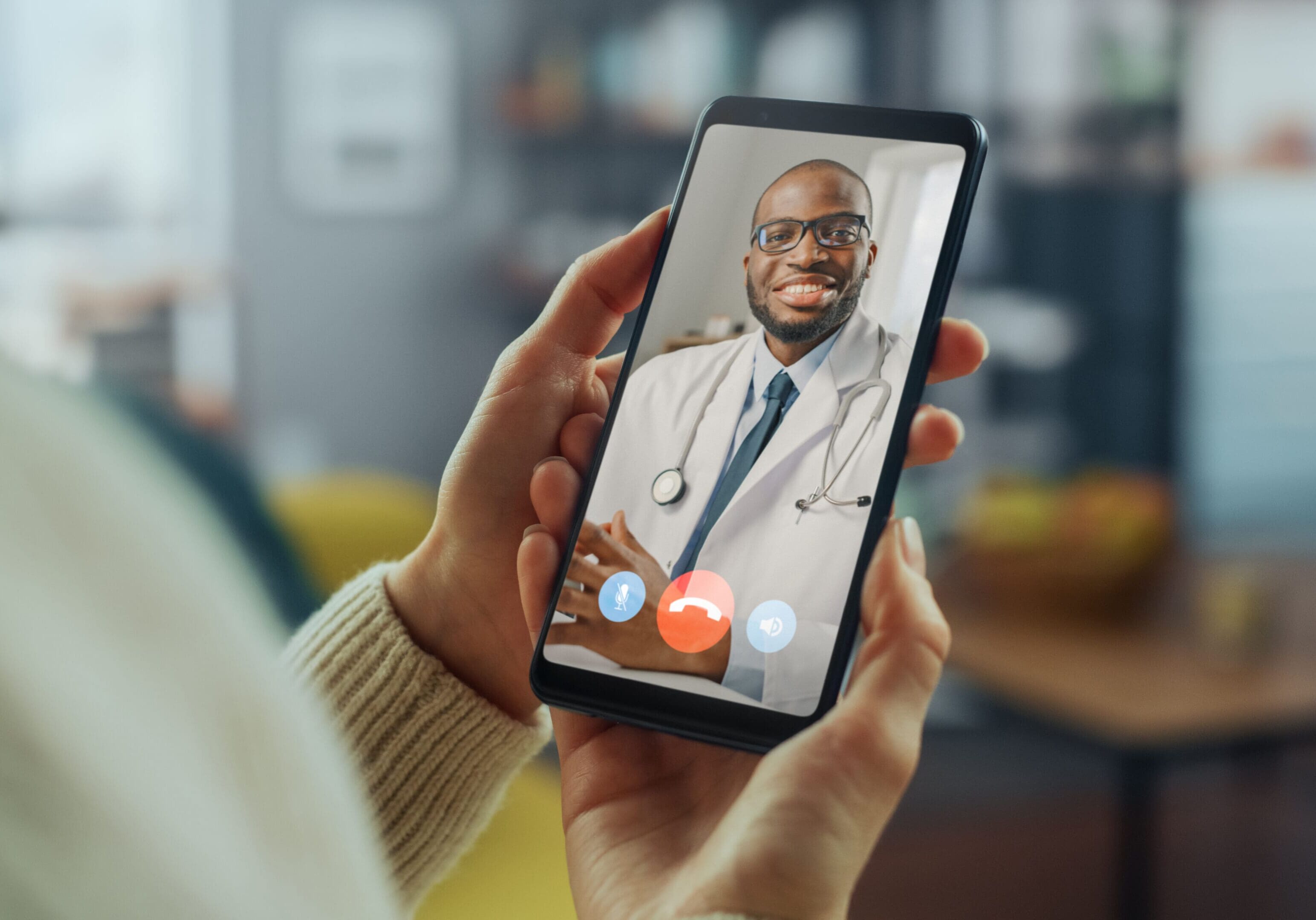 A person holding up their phone to take a picture of a doctor.